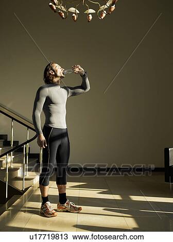 Mature man drinking water by steps View Large Photo Image Stock Image - Mature man drinking water by steps. Fotosearch