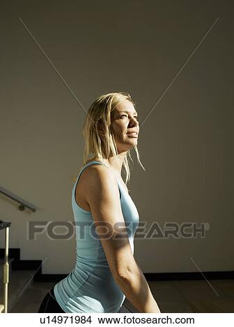 Woman stretching by steps, side view View Large Photo Image Picture - Woman stretching by steps, side view. Fotosearch
