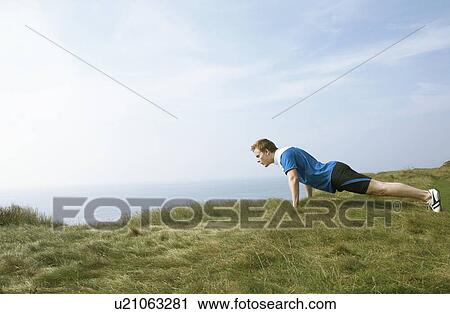 Young Man doing a press up. View Large Photo Image Stock Image - Young Man doing a press up.. Fotosearch
