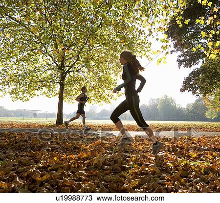 Young woman and man running. View Large Photo Image Stock Image - Young woman and man running.. Fotosearch