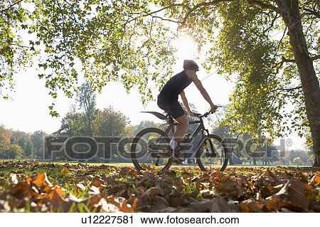 Cyclist riding mountain bike. View Large Photo Image Stock Image - Cyclist riding mountain bike.. Fotosearch