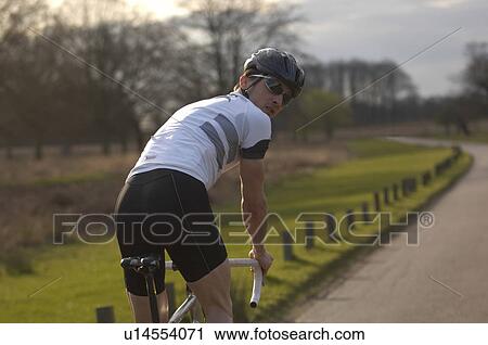 Man cycling in park View Large Photo Image Stock Image - Man cycling in park. Fotosearch