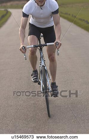 Man cycling in park View Large Photo Image Stock Image - Man cycling in park. Fotosearch