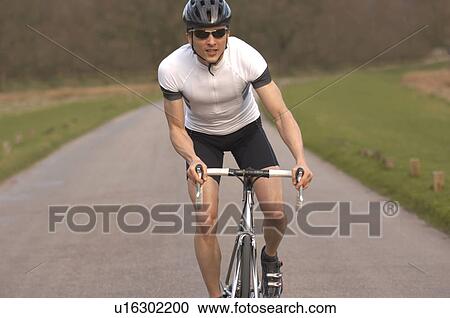 Man cycling in park View Large Photo Image Stock Image - Man cycling in park. Fotosearch