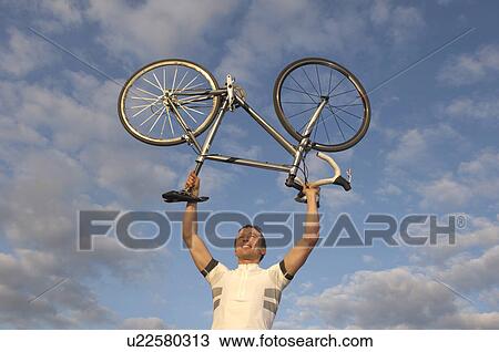 Man cycling in park View Large Photo Image Stock Image - Man cycling in park. Fotosearch