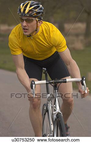 Man cycling in park View Large Photo Image Stock Image - Man cycling in park. Fotosearch
