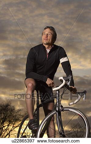 Man cycling in park View Large Photo Image Stock Photo - Man cycling in park. Fotosearch