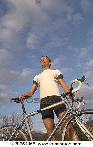 Stock Photography - Man cycling in park. Fotosearch