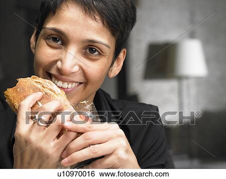 Businesswoman having a snack. Brussels, Belgium. View Large Photo Image Stock Photograph - Businesswoman having a snack. Brussels, Belgium.. Fotosearch