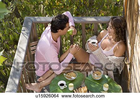 Picture - Couple eating breakfast outdoors.. Fotosearch