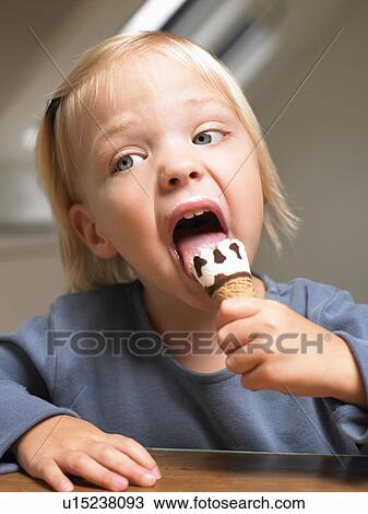 Little girl eating ice cream View Large Photo Image Stock Image - Little girl eating ice cream. Fotosearch