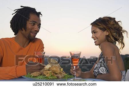Man and woman at a barbecue at sunset View Large Photo Image Stock Image - Man and woman at a barbecue at sunset. Fotosearch