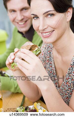 Stock Photo - Man and woman eating health food. Fotosearch