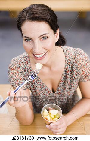 Woman eating fruits View Large Photo Image Stock Photo - Woman eating fruits. Fotosearch