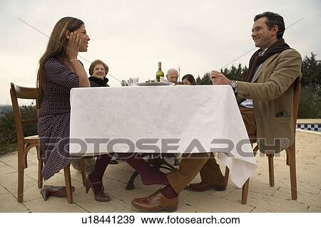 Woman flirting with man under table View Large Photo Image Stock Photo - Woman flirting with man under table. Fotosearch