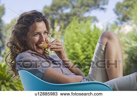 Woman on a wooden terrace by a pool View Large Photo Image Stock Image - Woman on a wooden terrace by a pool. Fotosearch