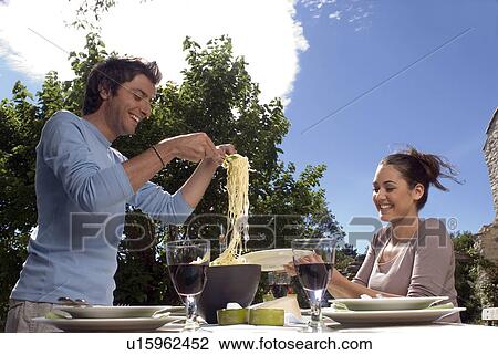 Young couple eating pasta View Large Photo Image Stock Image - Young couple eating pasta. Fotosearch