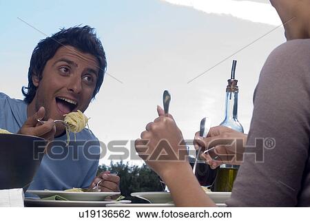 Young couple eating pasta View Large Photo Image Stock Image - Young couple eating pasta. Fotosearch