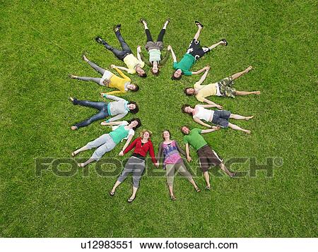 Crowd lying in grass in circle View Large Photo Image Stock Image - Crowd lying in grass in circle. Fotosearch
