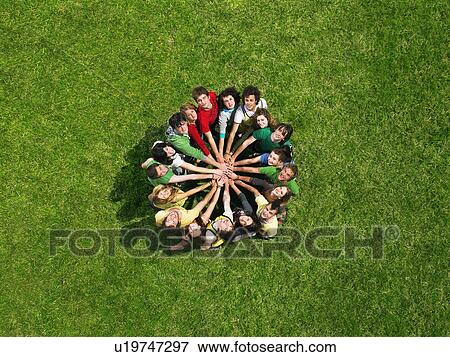 Group standing in a circle on grass View Large Photo Image Stock Photo - Group standing in a circle on grass. Fotosearch