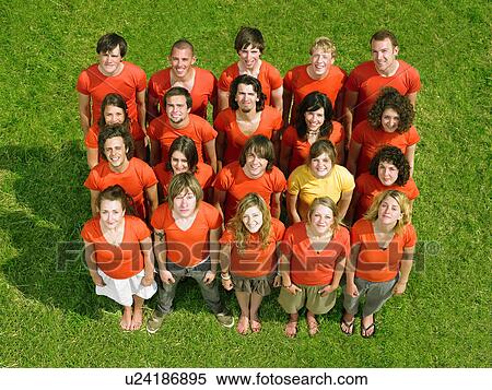 Group standing on grass all wearing orange one in yellow View Large Photo Image Stock Photography - Group standing on grass all wearing orange one in yellow. Fotosearch
