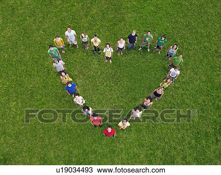 Group standing on grass in heart shape formation View Large Photo Image Stock Image - Group standing on grass in heart shape formation. Fotosearch