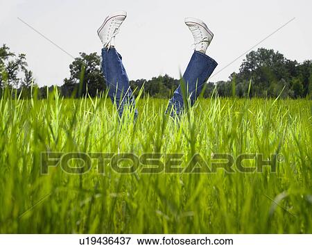 Stock Photo - Legs of a woman pointing towards the sky.. Fotosearch