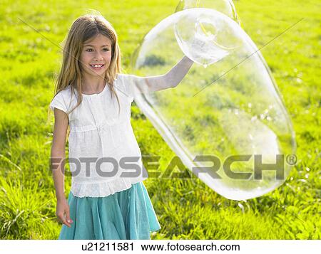 Little girl making soap bubbles. View Large Photo Image Stock Image - Little girl making soap bubbles.. Fotosearch