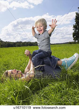 Mother and son playing in a field. View Large Photo Image Stock Photo - Mother and son playing in a field.. Fotosearch