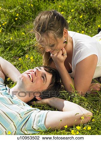 You couple lying in the grass. View Large Photo Image Stock Image - You couple lying in the grass.. Fotosearch