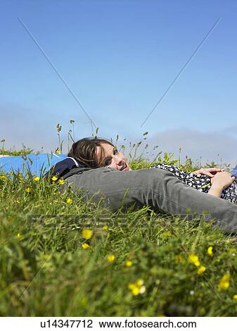 You couple lying in the grass. View Large Photo Image Stock Image - You couple lying in the grass.. Fotosearch