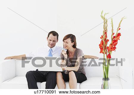 Couple on sofa purchase on-line View Large Photo Image Stock Image - Couple on sofa purchase on-line. Fotosearch