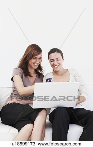 Female friends make online purchase View Large Photo Image Stock Image - Female friends make online purchase. Fotosearch
