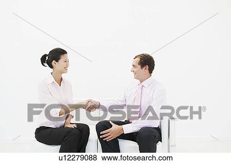 Stock Photo - Man and woman shaking hands. Fotosearch