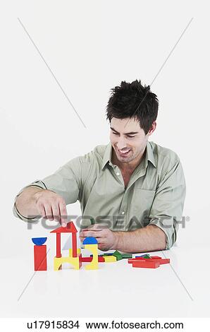 Man builds model house View Large Photo Image Picture - Man builds model house. Fotosearch