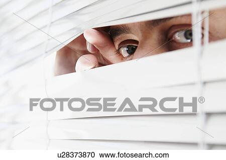 Man looking through office blinds View Large Photo Image Stock Image - Man looking through office blinds. Fotosearch
