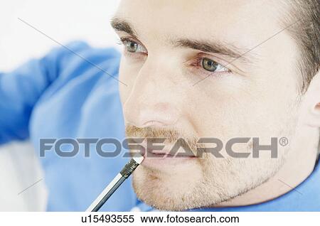 Stock Photography - Portrait of businessman with pencil. Fotosearch