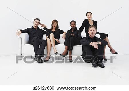 Stock Image - Relaxed, seated business group. Fotosearch