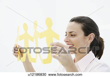 Smiling woman holds paper chain View Large Photo Image Stock Image - Smiling woman holds paper chain. Fotosearch