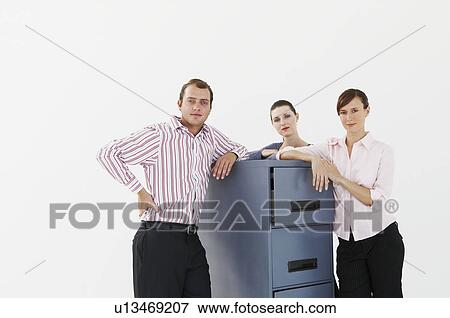 Stock Photo - Three business people lean on cabinet. Fotosearch