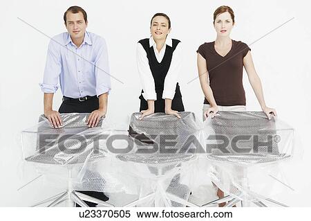 Stock Photography - Three people in new office. Fotosearch