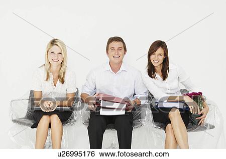 Three people smiling in new office View Large Photo Image Stock Photograph - Three people smiling in new office. Fotosearch