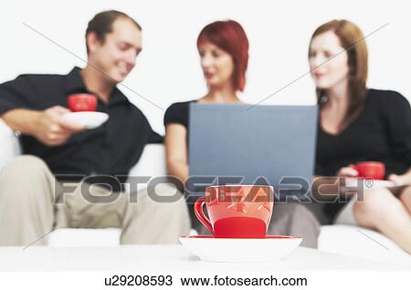 Three people talking with hot drink View Large Photo Image Stock Image - Three people talking with hot drink. Fotosearch