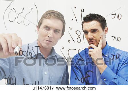 Two men write on glass panel View Large Photo Image Stock Photo - Two men write on glass panel. Fotosearch