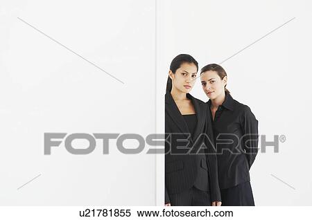 Two women in black look at camera View Large Photo Image Stock Photography - Two women in black look at camera. Fotosearch
