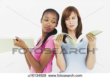 Stock Photo - Two women looking at files. Fotosearch