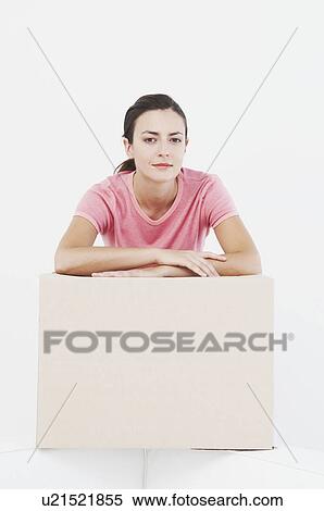 Stock Photography - Woman at home with storage box. Fotosearch