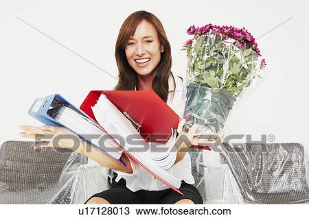 Woman laughing as she drops files View Large Photo Image Stock Image - Woman laughing as she drops files. Fotosearch