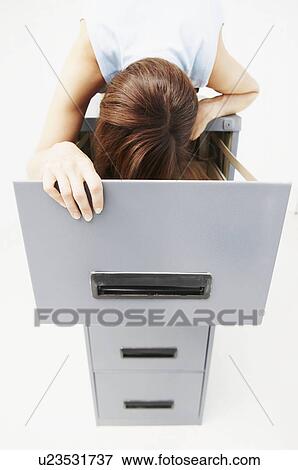 Woman looking for files in cabinet View Large Photo Image Stock Photo - Woman looking for files in cabinet. Fotosearch
