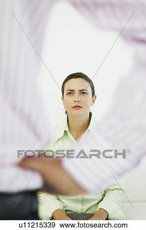 Woman looking up to colleague View Large Photo Image Stock Photo - Woman looking up to colleague. Fotosearch